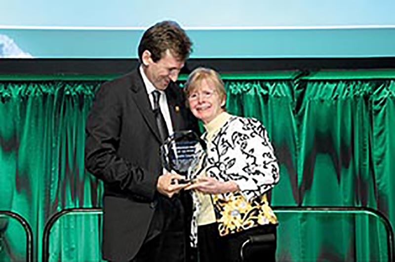 The Moment: Scott Tinker presents the award in Denver to Susan Landon.

