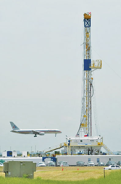 In Texas, the quest for energy can be found everywhere and anywhere –even at the Dallas-Fort Worth International Airport, where Chesapeake Energy has drilled and completed more than 40 wells as it works the Barnett shale. Chesapeake recently reported it expects to complete a Barnett well every 15 hours, on average, through 2012. At DFW the horizontal wells can sit up close to the edge of the runway and then drill right under the runway, providing almost unlimited opportunity for hydrocarbon recovery. Photo courtesy of Fort Worth Star-Telegram. 