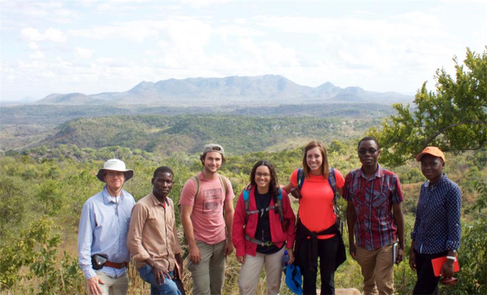 The research team poses in front of the Salambidwe Ring Complex at the boundary between Malawi and Mozambique